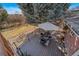 A high angle view of the back deck with a brick house and dining table at 5404 W Rowland Pl, Littleton, CO 80128