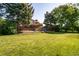 Expansive backyard with a spacious deck and patio, perfect for outdoor entertaining and enjoying the lush green lawn at 5404 W Rowland Pl, Littleton, CO 80128