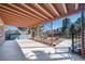 A covered patio extends out into a backyard with a small fire pit at 5404 W Rowland Pl, Littleton, CO 80128