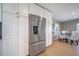 Kitchen with stainless steel refrigerator and a cozy dining area at 5404 W Rowland Pl, Littleton, CO 80128
