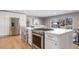 Open kitchen with stainless steel appliances and views of dining area at 5404 W Rowland Pl, Littleton, CO 80128
