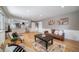 Spacious living room with hardwood floors, cozy seating, and view of the modern kitchen at 5404 W Rowland Pl, Littleton, CO 80128