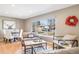 Cozy and well-lit living area with comfortable seating and a large window, creating a relaxing and inviting atmosphere at 5404 W Rowland Pl, Littleton, CO 80128