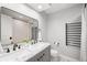 Modern bathroom features a double sink vanity, large mirror, and heated towel rack at 5810 S Galena St, Greenwood Village, CO 80111