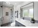 Modern bathroom with glass enclosed shower, rain showerhead, and sleek black fixtures at 5810 S Galena St, Greenwood Village, CO 80111