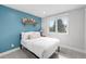 Cozy bedroom featuring a blue accent wall, a large window, and carpet flooring at 5810 S Galena St, Greenwood Village, CO 80111