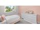 Serene bedroom featuring a pink bed, a large window, and a white dresser at 5810 S Galena St, Greenwood Village, CO 80111