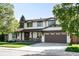 Beautiful two-story home featuring an attached garage, white paint, and well-maintained landscaping at 5810 S Galena St, Greenwood Village, CO 80111
