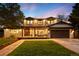 Stunning two-story home with a well-manicured lawn, inviting entrance, and attached garage at 5810 S Galena St, Greenwood Village, CO 80111