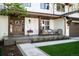Inviting front porch with outdoor seating, beautiful wooden door, and stylish potted flowers at 5810 S Galena St, Greenwood Village, CO 80111