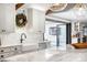 Bright kitchen features white cabinets, marble countertops, farmhouse sink, and stainless steel appliances at 5810 S Galena St, Greenwood Village, CO 80111