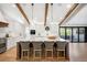 Elegant kitchen island with seating, pendant lighting, and access to the outdoor patio at 5810 S Galena St, Greenwood Village, CO 80111