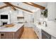 Modern kitchen featuring white cabinets, hardwood floors, and stainless steel appliances at 5810 S Galena St, Greenwood Village, CO 80111