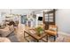 Open-concept living room connects to the kitchen with a sliding barn door to another room at 5810 S Galena St, Greenwood Village, CO 80111