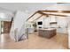 Open concept living area boasts exposed wood beams, light hardwood floors, and a cozy fireplace at 5810 S Galena St, Greenwood Village, CO 80111