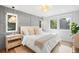 Light-filled main bedroom with stylish wall paneling and large windows overlooking lush greenery at 5810 S Galena St, Greenwood Village, CO 80111