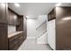 Basement storage area with dark cabinets and stairs at 5810 S Galena St, Greenwood Village, CO 80111