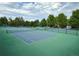 Well-maintained tennis courts surrounded by trees and greenery at a community center at 5810 S Galena St, Greenwood Village, CO 80111