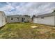 Spacious backyard with a well-maintained lawn, shed, and gray siding on the house at 9470 Lillian Ln, Thornton, CO 80229