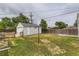 Backyard with shed, wooden fence, and lush greenery; features a clothesline at 9470 Lillian Ln, Thornton, CO 80229