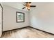Inviting bedroom featuring wood-style floors, ceiling fan, and ample natural light at 9470 Lillian Ln, Thornton, CO 80229