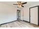 Bright bedroom featuring modern ceiling fan, neutral walls, and wood-look flooring at 9470 Lillian Ln, Thornton, CO 80229