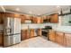 Updated kitchen with stainless steel appliances, granite countertops, and modern cabinetry at 9470 Lillian Ln, Thornton, CO 80229