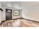 Bright living room with wood-look flooring, fresh paint, and new trim at 9470 Lillian Ln, Thornton, CO 80229