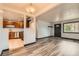Open living space featuring wood-look floors and view into the updated kitchen at 9470 Lillian Ln, Thornton, CO 80229