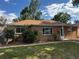 Charming brick home with a well-manicured lawn, mature trees, and beautiful landscaping at 1550 Eppinger Blvd, Thornton, CO 80229