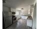 Modern kitchen featuring stainless appliances, granite countertops, white cabinets and wood-look floors at 1550 Eppinger Blvd, Thornton, CO 80229