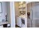 Convenient laundry room with washer, dryer, and storage shelves at 10700 Kimblewyck Cir # 154, Northglenn, CO 80233