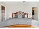 Comfortable main bedroom features warm wood accents, a large bed and neutral decor at 10700 Kimblewyck Cir # 154, Northglenn, CO 80233