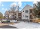 Attractive condo building featuring multiple units, balconies, and accessible parking, set against a partially snow-covered landscape at 6705 S Field St # 822, Littleton, CO 80128