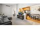 Living room leading to the kitchen, with a comfortable gray sofa and a small kitchen table at 6705 S Field St # 822, Littleton, CO 80128