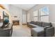 Relaxing living room with a gray sofa, a fireplace, and bright natural light through blinds on the windows at 6705 S Field St # 822, Littleton, CO 80128