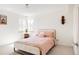 Bedroom featuring neutral walls, carpet and a bed with salmon colored bedding at 1010 N Jasmine St, Denver, CO 80220