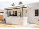 Front porch with cantilevered overhang, textured wall and mid-century modern style at 1010 N Jasmine St, Denver, CO 80220