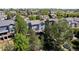 Aerial view of the backyard with a deck, green lawn, and mature trees at 20234 E Lake Cir, Centennial, CO 80016