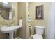 Cozy half bathroom with stylish pedestal sink and elegant decorative accents at 20234 E Lake Cir, Centennial, CO 80016