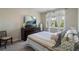 Calm bedroom with a large bed, TV, dresser, and window with natural light at 20234 E Lake Cir, Centennial, CO 80016