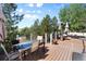 Relaxing deck area with glass-top table and lush greenery views at 20234 E Lake Cir, Centennial, CO 80016
