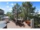 Spacious deck featuring a dining table with umbrella, grill, and railing with scenic tree views at 20234 E Lake Cir, Centennial, CO 80016