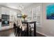 Cozy dining area with a dark wood table, comfortable seating, and large windows offering plenty of natural light and backyard views at 20234 E Lake Cir, Centennial, CO 80016