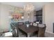 Elegant dining room featuring a crystal chandelier, colorful artwork, and a convenient bar area, perfect for entertaining guests at 20234 E Lake Cir, Centennial, CO 80016