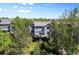 Rear exterior view of the home featuring decks, a landscaped yard, and mature trees at 20234 E Lake Cir, Centennial, CO 80016