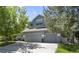 Charming two-story home featuring a three-car garage and lush landscaping at 20234 E Lake Cir, Centennial, CO 80016