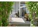 The inviting front porch has a charming bench, potted plants, and a lovely front door with windows at 20234 E Lake Cir, Centennial, CO 80016
