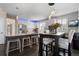 Modern kitchen featuring stainless steel appliances, white cabinets, and a dining area at 20234 E Lake Cir, Centennial, CO 80016