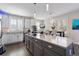 Bright, airy kitchen with white cabinets, a large island, hardwood floors, and modern stainless steel appliances at 20234 E Lake Cir, Centennial, CO 80016